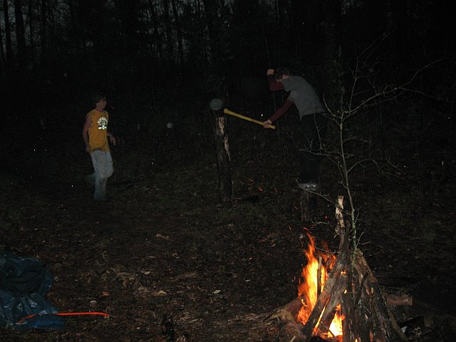 Doug standing on wood piece to split 4 food log